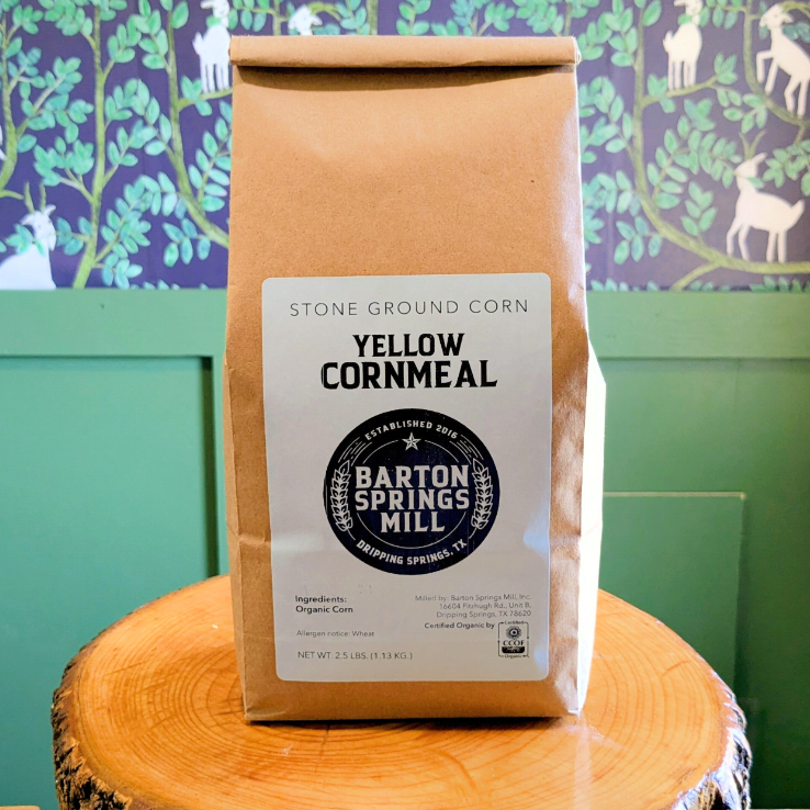 A bag of stone-ground Barton Springs Mill Yellow Cornmeal on a wooden crate 
